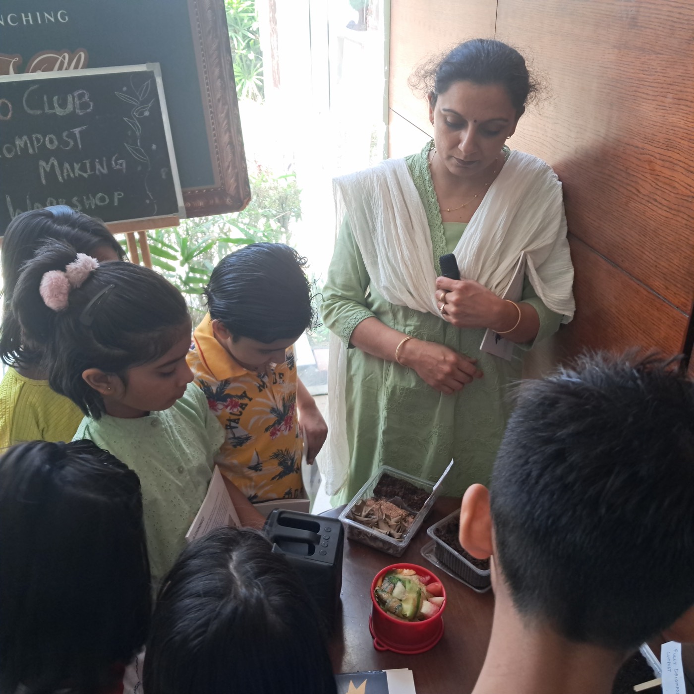Children watching a compost demonstration