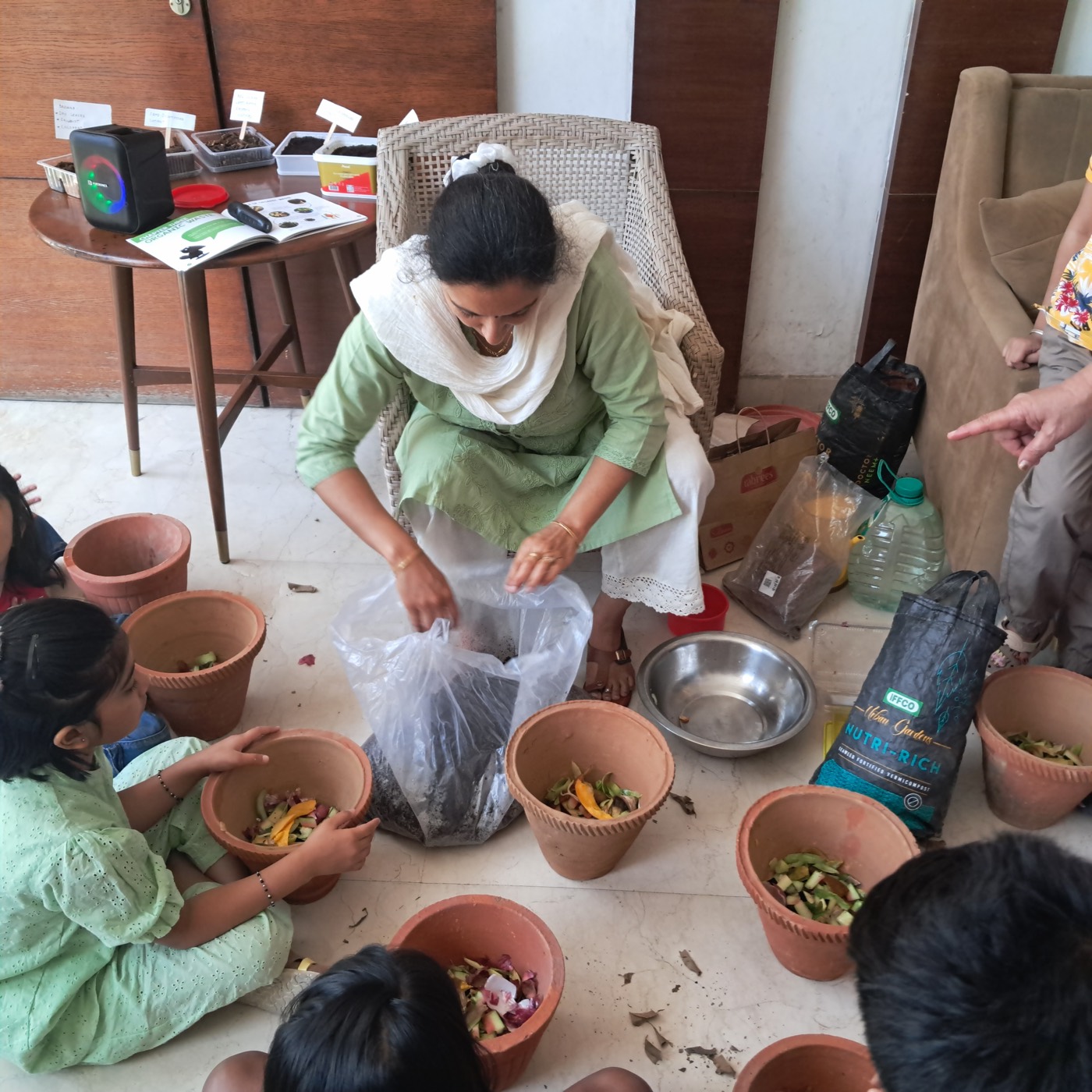Children filling terracotta pots during the workshop
